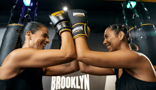 Two Fitboxers celebrate after a workout